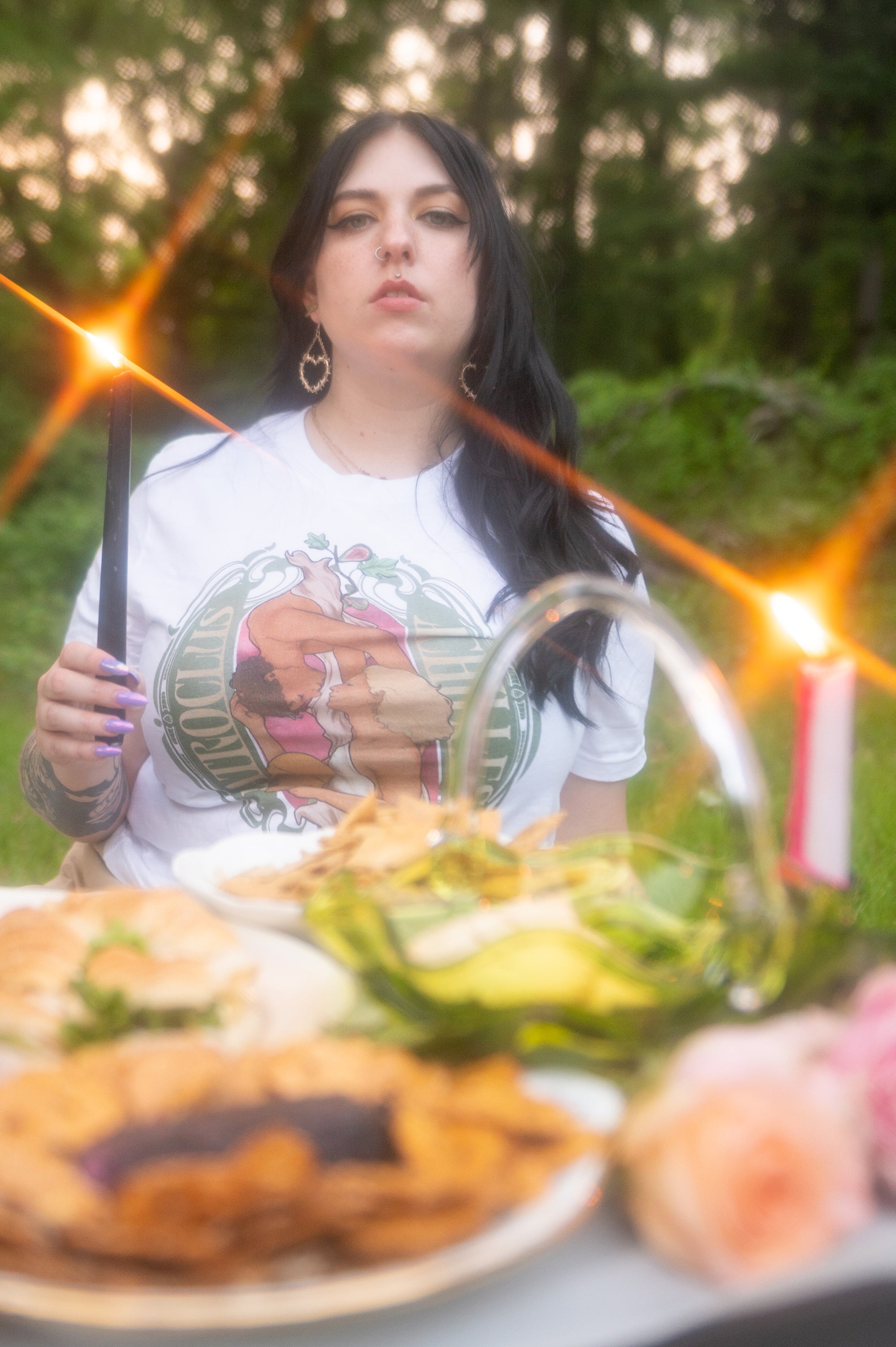 Woman at a feast wearing an Achilles and Patroclus festival style tee